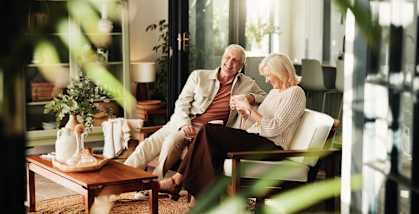 Two people sitting at a table in a brightly lit room.
