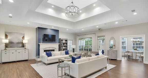 a living room with shelves and a hallway to a bedroom and a kitchen at Ashford Place Apartment Homes, Flowood, 39232