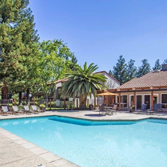 a swimming pool in front of a house with a pool at Valley Plaza Villages, Pleasanton, 94566