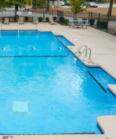 the pool is filled with blue water at the resort