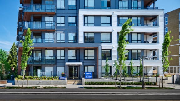 a rendering of a new condo building on a city street