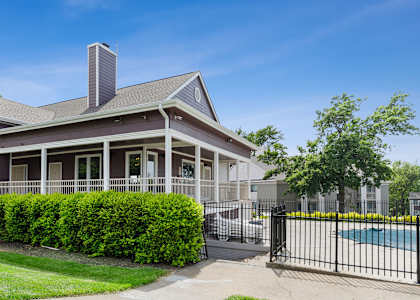 a house with a pool in front of it at Eastwood Crossings in Kansas City, Missouri