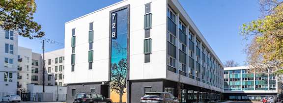 a computer generated image of a large office building with cars parked in front of it at THE MOD AT MIDTOWN Apartments, SACRAMENTO,  California