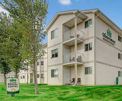 The exterior of Aspen Terrace with green space. 