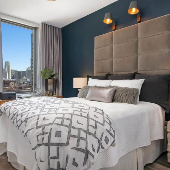 a bedroom with a large bed and a window