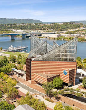an aerial view of a city with a river and a bridge