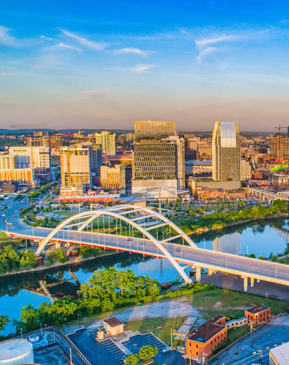 A cityscape with a river running through it and a bridge crossing over it.
