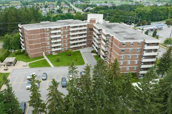 an aerial view of a large building in a parking lot