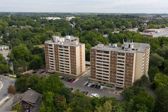 an aerial view of two highrise buildings in a city