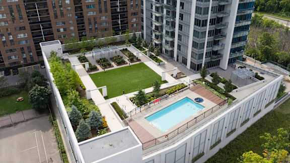 an aerial view of the courtyard of a building with a pool and lawn