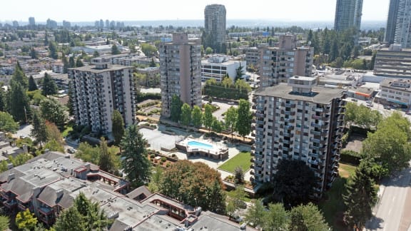 an aerial view of a city with tall buildings and trees