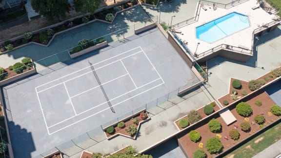 an aerial view of a tennis court and a pool