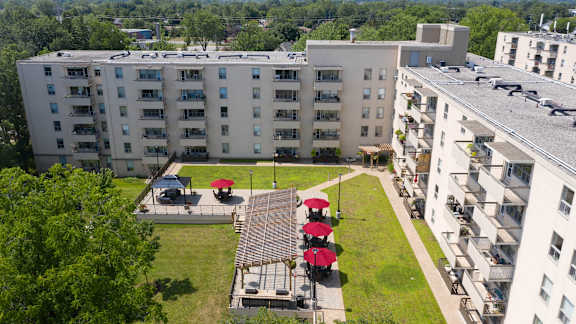 an aerial view of the courtyard of an apartment building with picnic tables