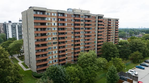 an aerial view of an apartment building in a park