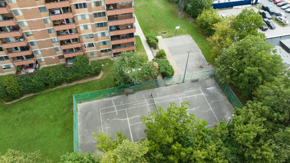 an aerial view of a tennis court in a park