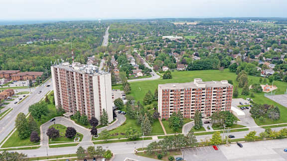 an aerial view of a city with buildings and a green park