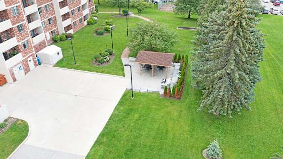 an aerial view of a park with a gazebo and a tree