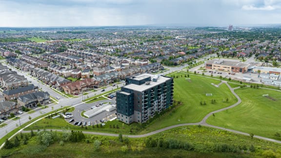 an aerial view of a city with a building and a parking lot