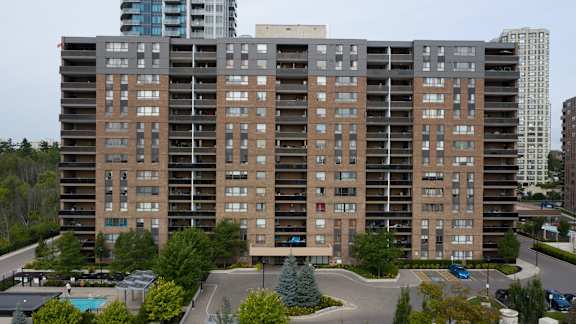 an aerial view of an apartment building with a parking lot