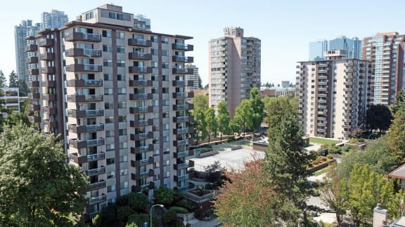 an aerial view of a city with tall buildings and trees