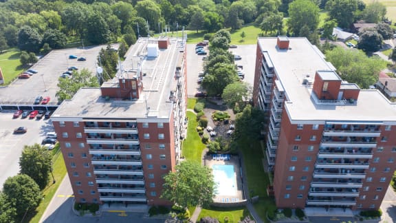 an aerial view of an apartment complex with a swimming pool