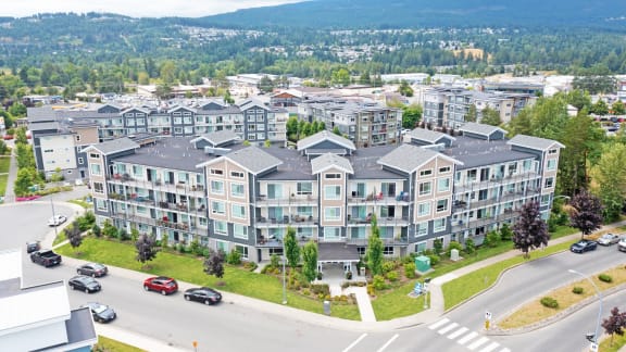 an aerial view of a large apartment building on a city street