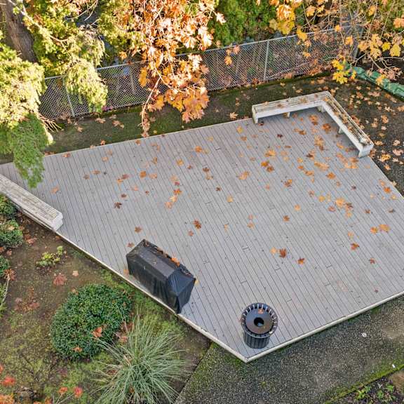 A roof with a grey shingle and a black box on it.