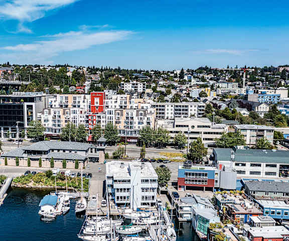 The cityscape of Seattle with the harbor in the foreground, the bridge in the background and the apartments of St. James Tower Apartments. 