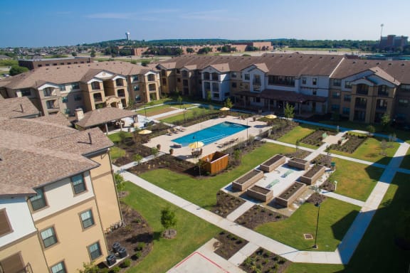 an aerial view of an apartment complex with a swimming pool at Mariposa at Elk Drive, Burleson Texas