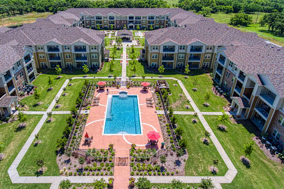an aerial view of the courtyard and pool at the overlook estates at Mariposa at South Broadway, Joshua, TX