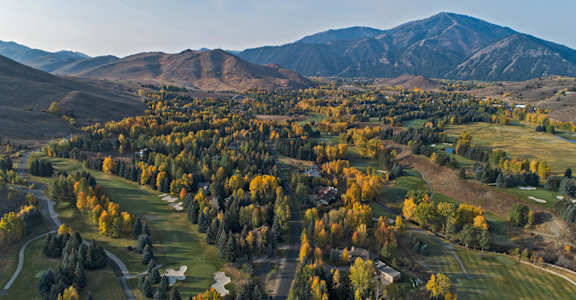 A small town surrounded by mountains and trees in the fall at The Woods at Copper Ranch, Hailey, ID