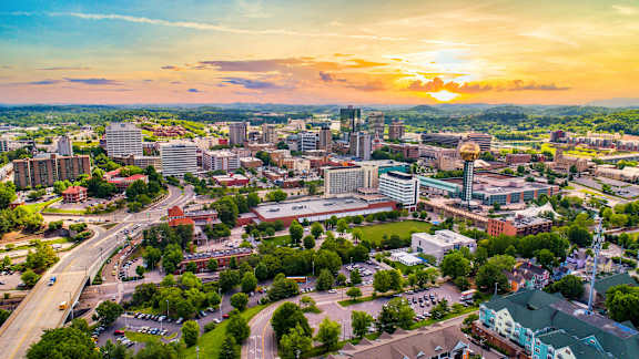 A cityscape with a sunset in the background.