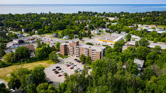 an aerial view of a city with a building and parking lot