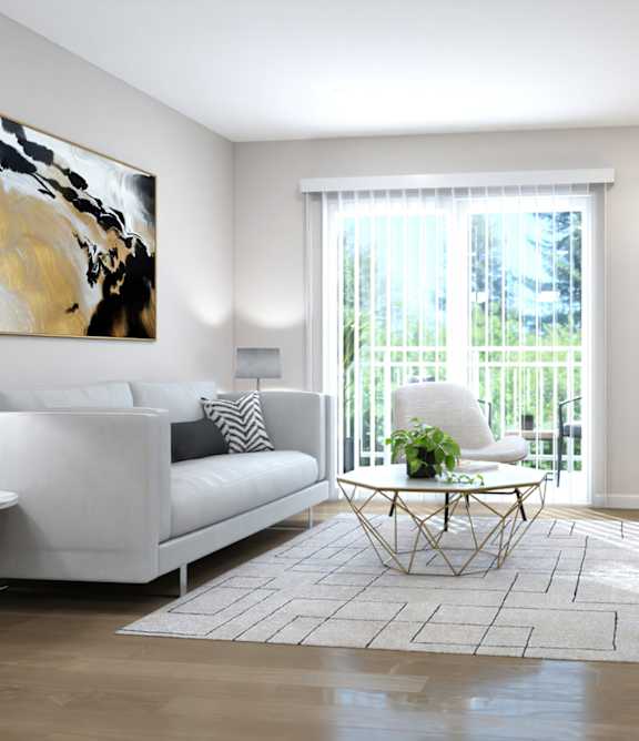 A living room with a white couch, a painting on the wall, and a potted plant.