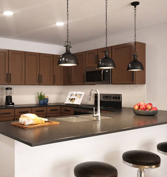 A modern kitchen with a refrigerator, sink, and bar stools.