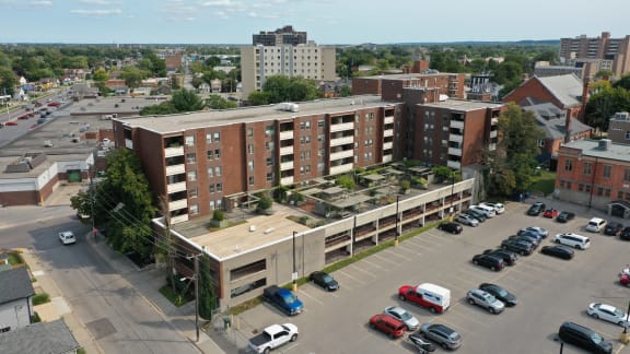 an aerial view of a parking lot and buildings in a city