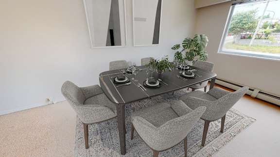 A grey table with four chairs and a potted plant on it.