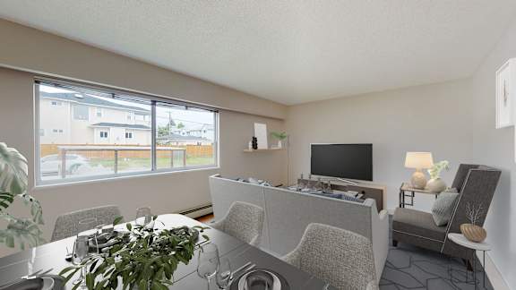 A living room with a grey couch and a television.