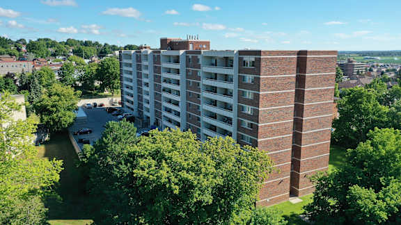 an aerial view of a tall building surrounded by trees