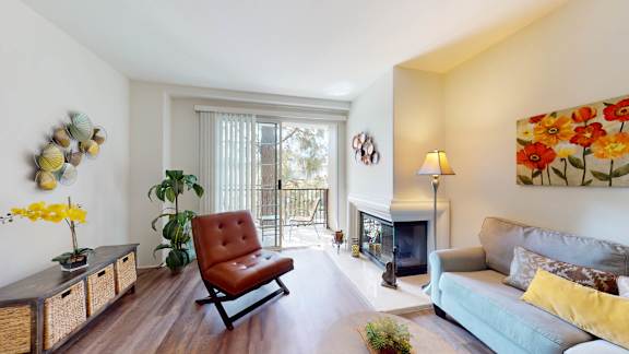 a living room with a couch and a chair and a fireplace