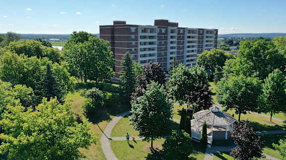 an aerial view of a park with a gazebo and a large building