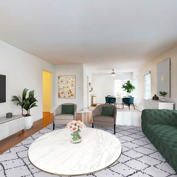 a living room with a green couch and a television  at Sunset Barrington Gardens, Los Angeles, California