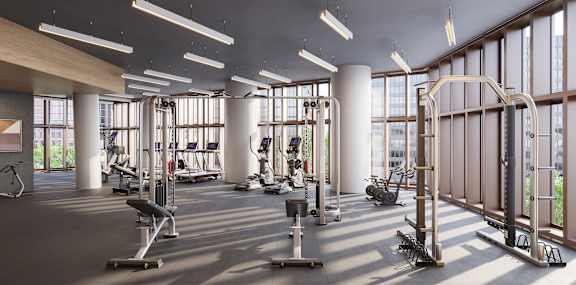 A gym with a variety of equipment including treadmills, weights, and exercise machines.