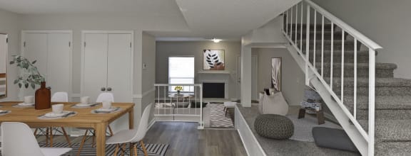 a living room and dining room with a staircase