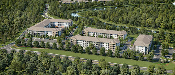 A bird's eye view of a resort surrounded by trees.