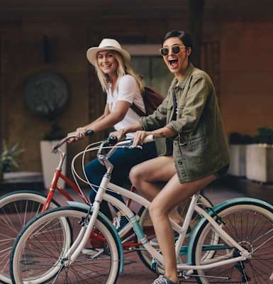 Two people riding a bicycle together.