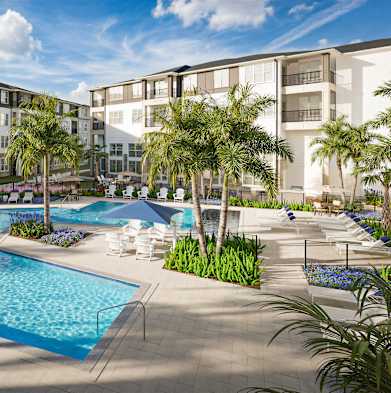 A large swimming pool surrounded by palm trees and lounge chairs.