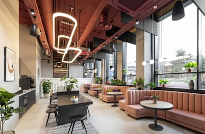 a lobby with couches and tables and a large window