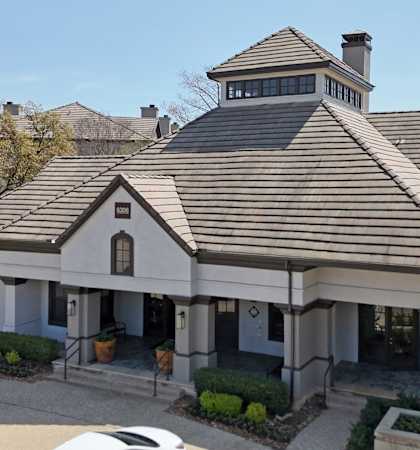 A house with a brown roof and a white garage door.