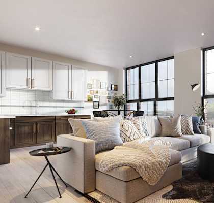 A modern living room with a large couch, a coffee table, and a view of the city.